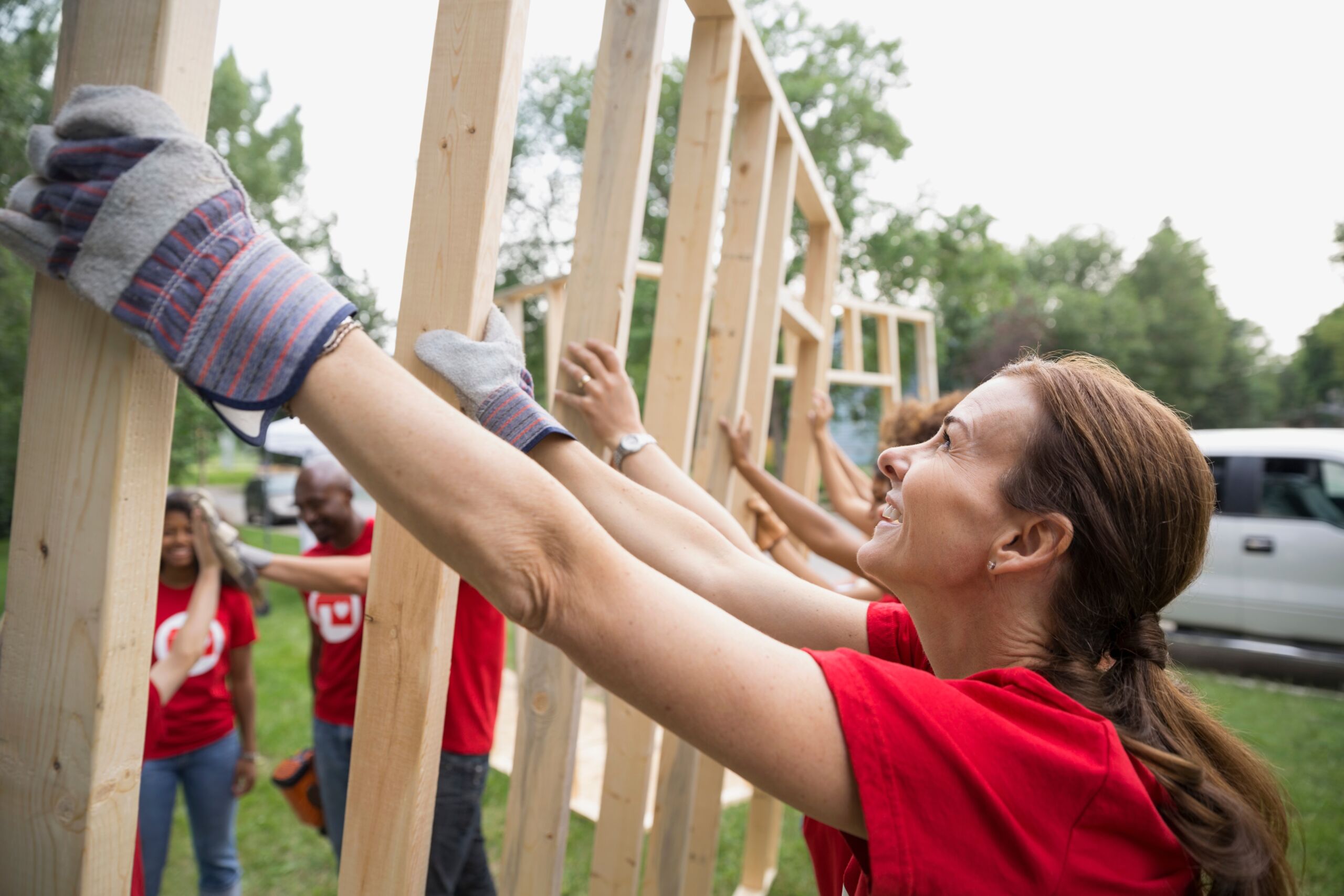 Smiling,Volunteers,Lifting,Construction,Frame